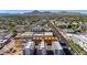 Stunning aerial image showcases newly built townhomes with road and lush landscape in a vibrant city setting on a clear day at 4220 N 32Nd St # 14, Phoenix, AZ 85018