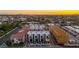 A dynamic aerial view of modern townhouses with balconies, set against a cityscape, merging urban style at 4220 N 32Nd St # 14, Phoenix, AZ 85018