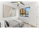 Minimalist bedroom with neutral tones, simple furnishings, and a black-framed window at 4220 N 32Nd St # 14, Phoenix, AZ 85018