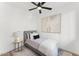 Cozy bedroom with a ceiling fan, a bed with throw pillows, and an art piece at 4220 N 32Nd St # 14, Phoenix, AZ 85018