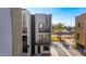 Modern townhome showcasing private balconies, sleek design and street view on a clear day, in a vibrant neighborhood setting at 4220 N 32Nd St # 14, Phoenix, AZ 85018