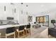 Open-concept layout with island seating, modern lighting, and view to a stylish living area at 4220 N 32Nd St # 14, Phoenix, AZ 85018