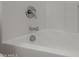 White tiled bathtub with silver hardware at 4745 W Fremont Rd, Laveen, AZ 85339