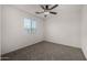 Well-lit bedroom with carpet and a ceiling fan at 4745 W Fremont Rd, Laveen, AZ 85339