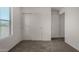 Bedroom featuring gray carpet, closet and a bright window at 4745 W Fremont Rd, Laveen, AZ 85339