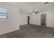 Large bedroom with neutral carpet, arched doorway, and ceiling fan at 4745 W Fremont Rd, Laveen, AZ 85339