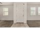 Bright entryway featuring a white front door, neutral walls, carpet, and light-colored tile flooring at 4745 W Fremont Rd, Laveen, AZ 85339