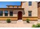 Charming two-story home features a red front door, stucco facade, and well-manicured landscaping at 4745 W Fremont Rd, Laveen, AZ 85339