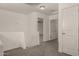 Upstairs hallway featuring carpet, white walls, doors and access to other rooms at 4745 W Fremont Rd, Laveen, AZ 85339