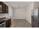 Bright kitchen with stainless steel appliances, tile floors, and brown cabinets, perfect for cooking and dining at 4745 W Fremont Rd, Laveen, AZ 85339