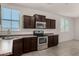 Cozy kitchen with modern stainless steel appliances, dark cabinetry, and bright natural lighting at 4745 W Fremont Rd, Laveen, AZ 85339
