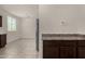 Bright kitchen features tile floors, stainless steel refrigerator, and brown cabinets with laminate countertops at 4745 W Fremont Rd, Laveen, AZ 85339