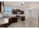 Well-lit kitchen with stainless steel appliances, wood cabinetry and tiled floors at 4745 W Fremont Rd, Laveen, AZ 85339