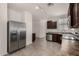 Well-lit kitchen offers stainless steel appliances, tile floors, and ample cabinet space at 4745 W Fremont Rd, Laveen, AZ 85339