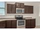 Well-lit kitchen with stainless steel oven, wood cabinetry, and bright natural lighting at 4745 W Fremont Rd, Laveen, AZ 85339