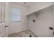 Bright laundry room featuring tile flooring, window with blinds, and utility connections at 4745 W Fremont Rd, Laveen, AZ 85339