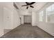 Inviting living room featuring neutral walls, carpet, tile flooring, three windows and a ceiling fan at 4745 W Fremont Rd, Laveen, AZ 85339