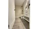 Modern bathroom featuring a walk-in shower, sleek vanity with black hardware, and stylish gray tile flooring at 4902 S Fair Ln, Tempe, AZ 85282
