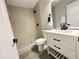 Modern bathroom featuring a walk-in shower, sleek vanity with black hardware, and stylish gray tile flooring at 4902 S Fair Ln, Tempe, AZ 85282