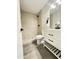Modern bathroom featuring a walk-in shower, sleek vanity with black hardware, and stylish gray tile flooring at 4902 S Fair Ln, Tempe, AZ 85282