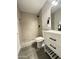 Modern bathroom featuring a walk-in shower, sleek vanity with black hardware, and stylish gray tile flooring at 4902 S Fair Ln, Tempe, AZ 85282