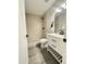 Modern bathroom featuring a walk-in shower, sleek vanity with black hardware, and stylish gray tile flooring at 4902 S Fair Ln, Tempe, AZ 85282