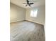 Bright bedroom with neutral walls, tile floors, modern ceiling fan and a window offering natural light at 4902 S Fair Ln, Tempe, AZ 85282