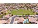 Community aerial view showcasing lush green space and surrounding neighborhood at 5737 W Hidalgo Ave, Laveen, AZ 85339
