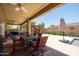 Inviting backyard patio with a dining set and outdoor ceiling fan at 5737 W Hidalgo Ave, Laveen, AZ 85339