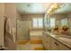 Bright bathroom with a glass shower, tub, and granite countertops at 5737 W Hidalgo Ave, Laveen, AZ 85339