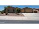 Charming single-story home with a well-manicured gravel front yard and a spacious two-car garage at 5737 W Hidalgo Ave, Laveen, AZ 85339