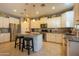 Bright kitchen with stainless steel appliances, granite countertops, ample storage, and a convenient breakfast bar at 5737 W Hidalgo Ave, Laveen, AZ 85339