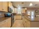 Modern kitchen featuring granite countertops, stainless steel appliances, and a functional island for meal preparation at 5737 W Hidalgo Ave, Laveen, AZ 85339