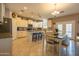 Well-lit kitchen with white cabinetry, granite countertops, a center island, and modern appliances at 5737 W Hidalgo Ave, Laveen, AZ 85339