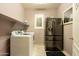 Laundry room with washer, dryer, refrigerator and tiled flooring at 5737 W Hidalgo Ave, Laveen, AZ 85339
