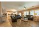 Spacious living room featuring hardwood floors and comfortable seating arrangements, with an open view to the kitchen at 5737 W Hidalgo Ave, Laveen, AZ 85339