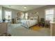 Comfortable bedroom featuring carpet flooring, plantation shutters, a cozy bed, and elegant decor at 5737 W Hidalgo Ave, Laveen, AZ 85339