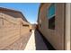 Narrow side yard between two buildings with a brick walkway at 5737 W Hidalgo Ave, Laveen, AZ 85339