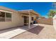 Home's backyard with a covered patio and desert landscape with a clear blue sky at 64 N 63Rd St # 25, Mesa, AZ 85205
