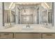 Bright bathroom featuring a vanity with sink and mirror reflecting the bedroom at 64 N 63Rd St # 25, Mesa, AZ 85205
