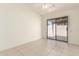 Tile bedroom with an attached slider leading to the outside area of the property at 64 N 63Rd St # 25, Mesa, AZ 85205