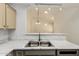 Close-up of the stainless steel kitchen sink and marble countertops at 64 N 63Rd St # 25, Mesa, AZ 85205