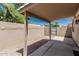 Covered patio with a gravel area and a walled perimeter under a blue sky at 64 N 63Rd St # 25, Mesa, AZ 85205