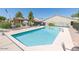 Community pool featuring clear blue water, surrounding lounge chairs and picnic area at 64 N 63Rd St # 25, Mesa, AZ 85205