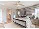 Stylish bedroom with a plaid accent wall, plush bedding, and plenty of natural light at 654 N Vine St, Chandler, AZ 85225