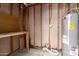 Unfinished basement with workbench and hot water heater at 6606 N 46Th Ave, Glendale, AZ 85301