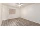 A standard bedroom with wood-look floors and a ceiling fan at 6606 N 46Th Ave, Glendale, AZ 85301