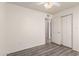 A standard bedroom with closet, wood-look floors, and a ceiling fan at 6606 N 46Th Ave, Glendale, AZ 85301