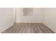 A compact bedroom with wood-look floors and natural light at 6606 N 46Th Ave, Glendale, AZ 85301