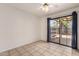 Light-filled room features tile flooring, ceiling fan, and a sliding glass door to the outside at 6606 N 46Th Ave, Glendale, AZ 85301